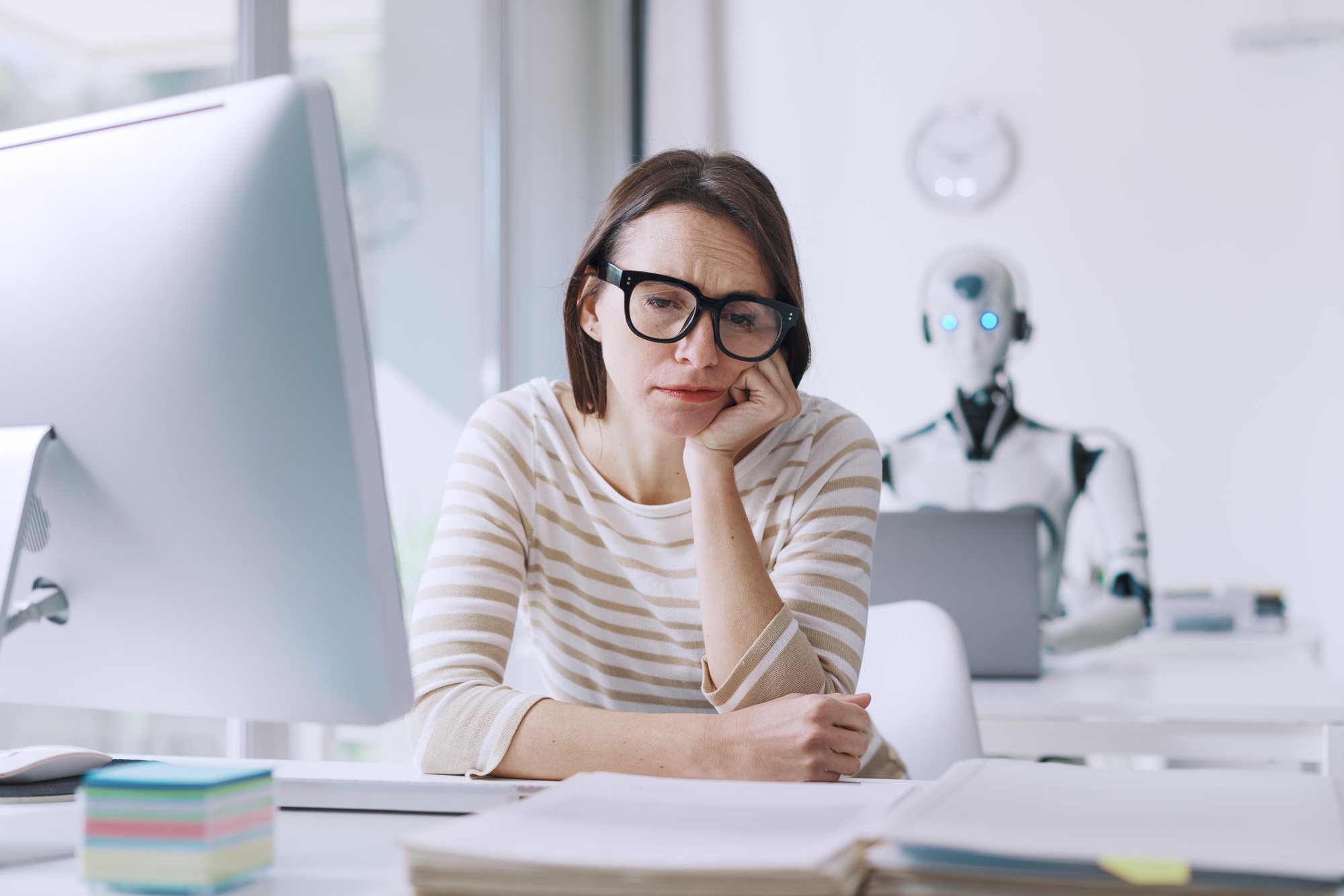 Disappointed stressed woman and AI robot in the office